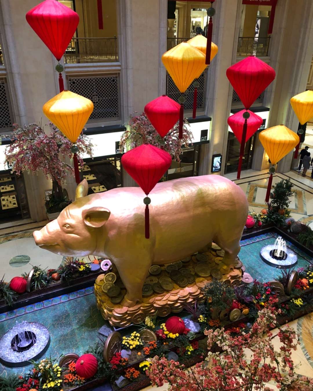 Large gold pig with flowers and fountain